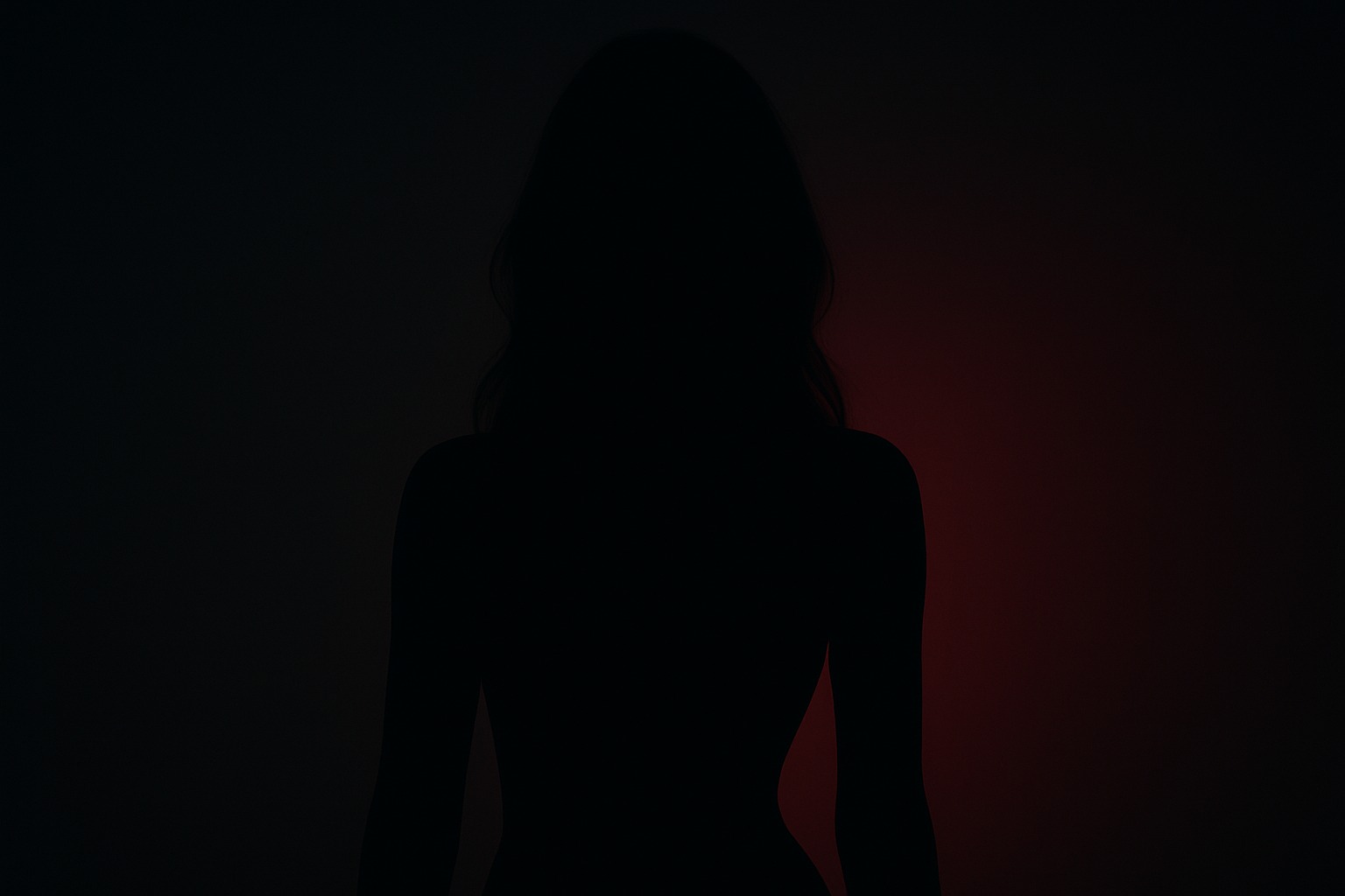 Silhouette d'une femme avec un effet d'ombre et de lumière rouge